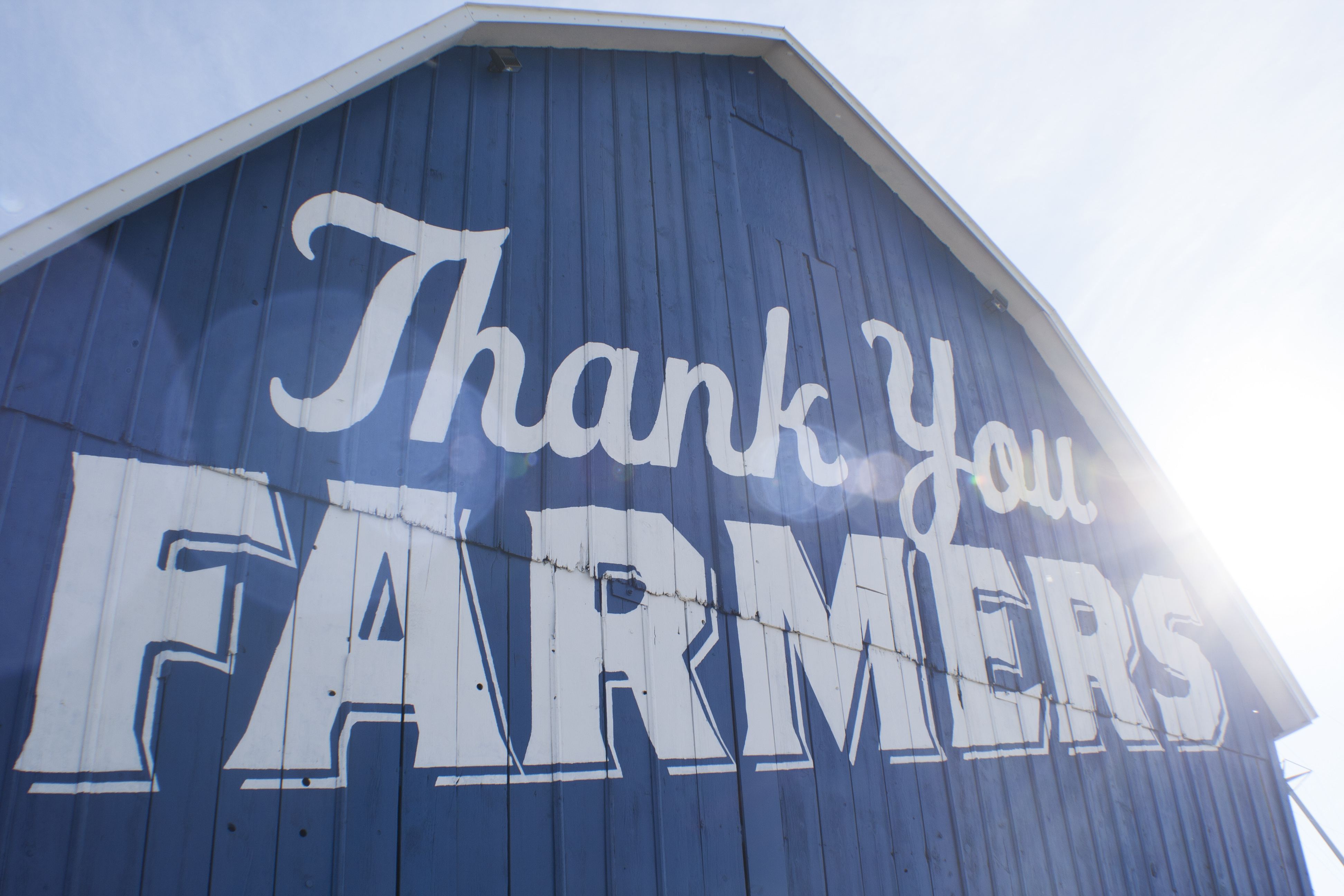 A blue barn representing local farming and community support